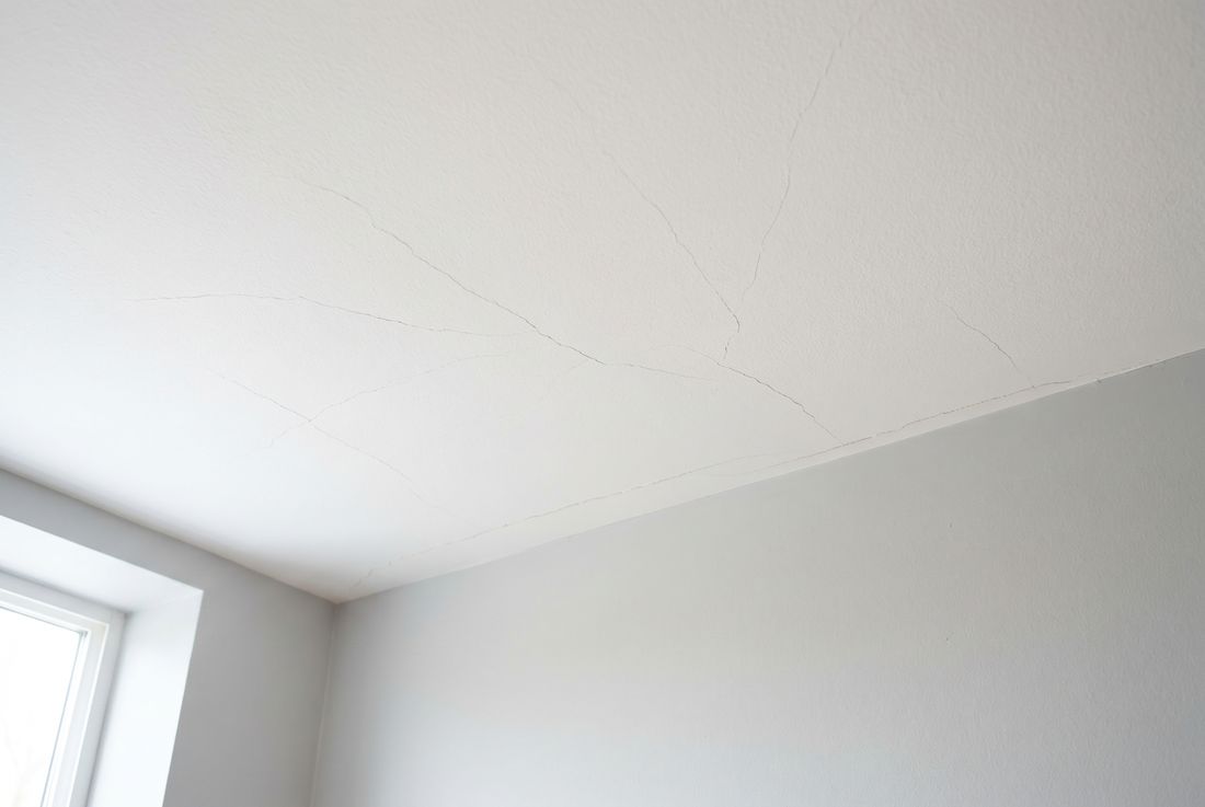 Residential ceiling with hairline stress cracks radiating across the surface &mdash; Aurora ceiling crack repair