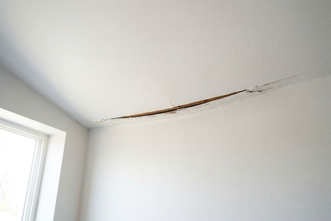 Sagging ceiling drywall pulled away from framing along a ceiling-wall seam &mdash; Aurora sagging ceiling repair